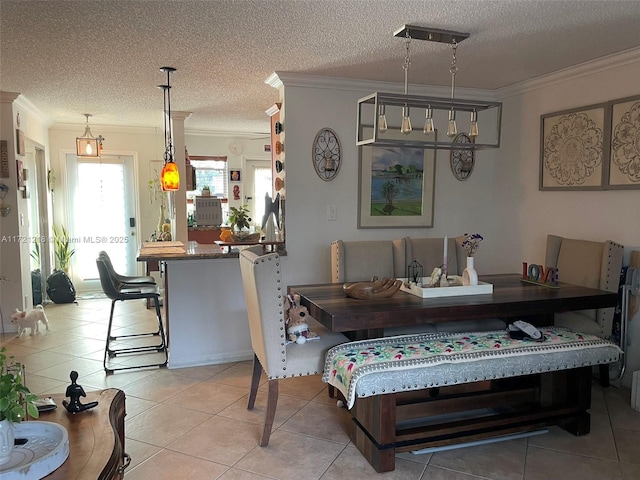 dining area with light tile patterned floors, a textured ceiling, and ornamental molding