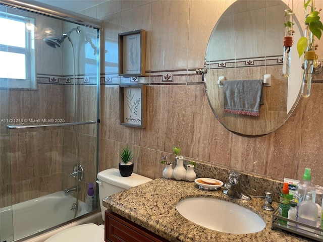 full bathroom with vanity, toilet, and shower / bath combination with glass door