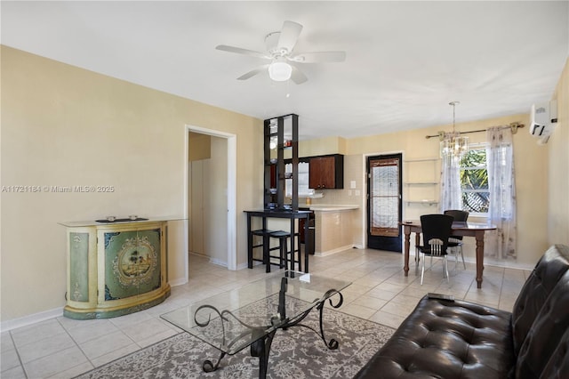 living room featuring a wall unit AC, light tile patterned floors, and ceiling fan with notable chandelier