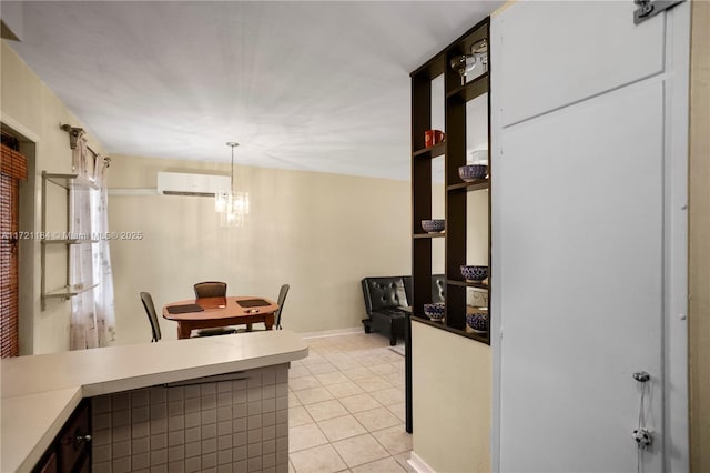 interior space with light tile patterned flooring, a wall unit AC, and a chandelier