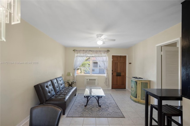 living room featuring light tile patterned floors, a wall unit AC, and ceiling fan