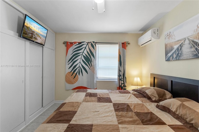 bedroom featuring ceiling fan, light tile patterned floors, and a wall unit AC