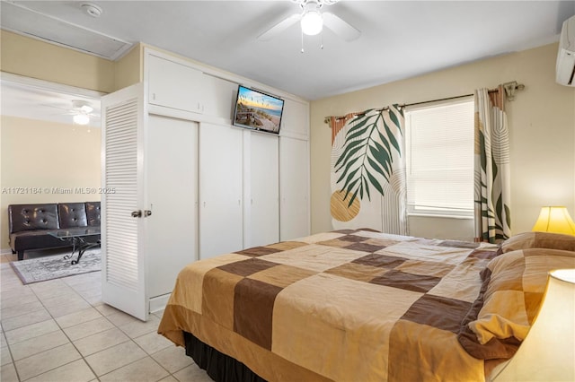 bedroom with an AC wall unit, ceiling fan, and light tile patterned flooring