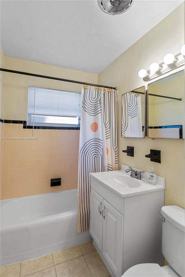 full bathroom featuring toilet, vanity, tile patterned floors, and shower / bathtub combination with curtain