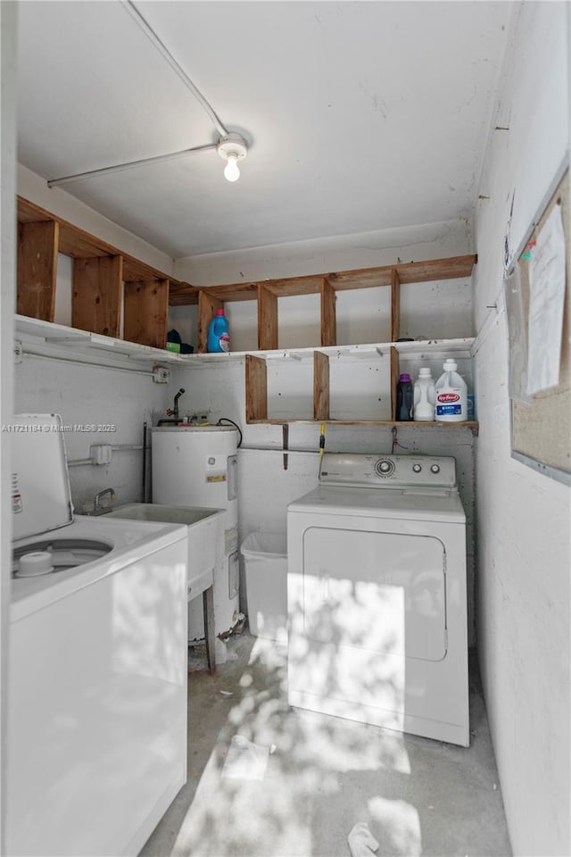 laundry area with washer and clothes dryer and water heater