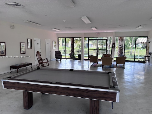 recreation room featuring a wealth of natural light, a textured ceiling, billiards, and french doors