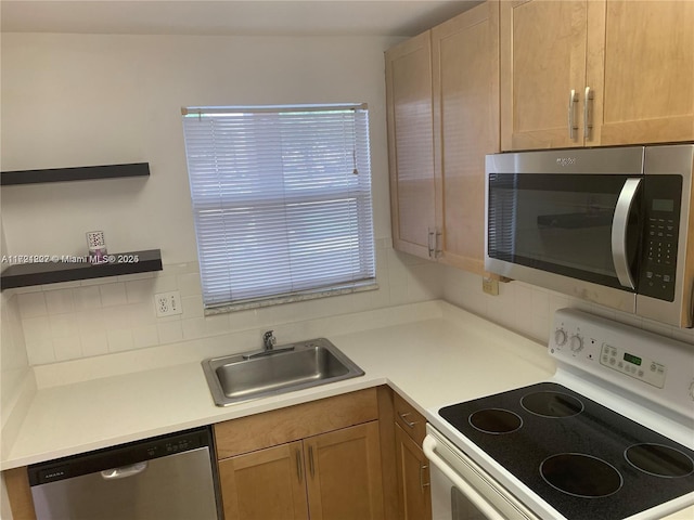 kitchen with backsplash, sink, and stainless steel appliances