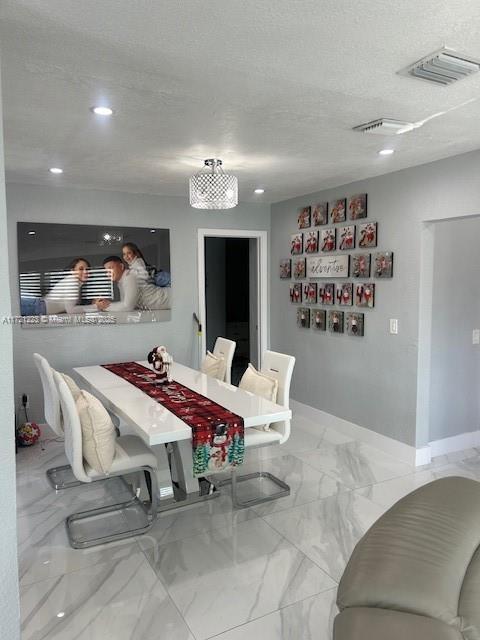 dining space featuring a textured ceiling