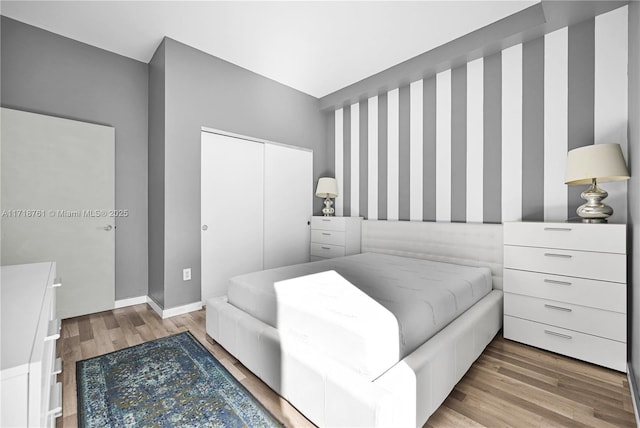 bedroom with a closet and light hardwood / wood-style flooring