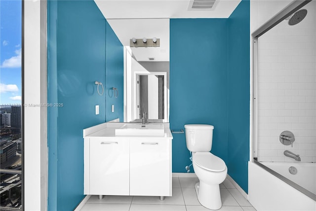 full bathroom featuring toilet, vanity, tile patterned flooring, and tiled shower / bath combo