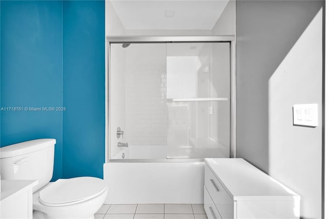 full bathroom with toilet, vanity, tile patterned flooring, and shower / bath combination with glass door