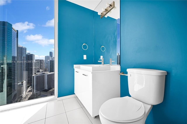 bathroom featuring toilet, vanity, and tile patterned floors