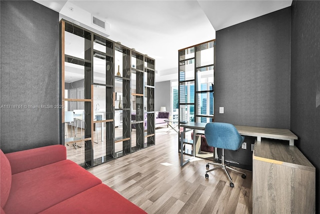 home office with wood-type flooring