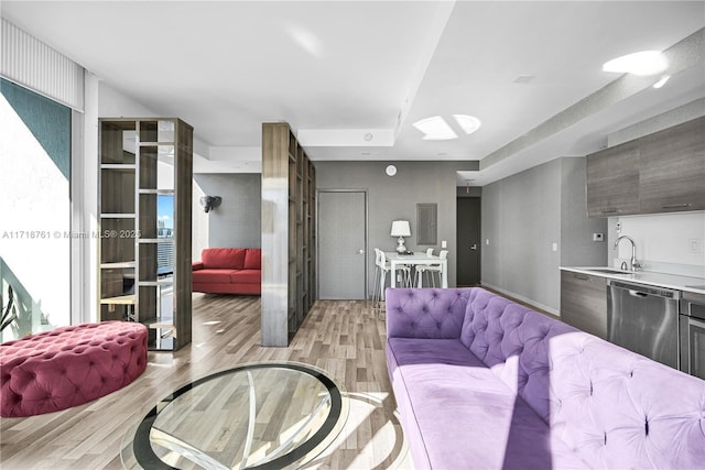 living room featuring light wood-type flooring and sink