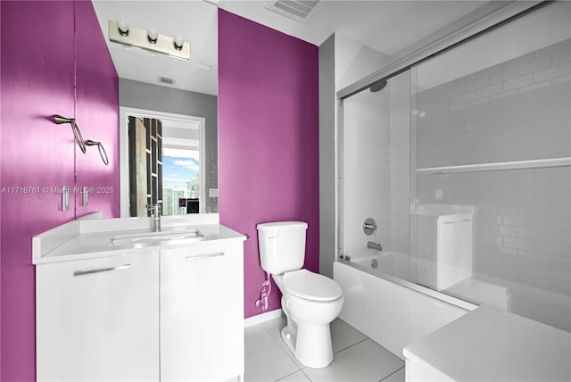 full bathroom featuring toilet, bath / shower combo with glass door, tile patterned floors, and vanity