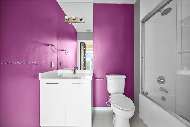 full bathroom with toilet, tile patterned flooring, vanity, and shower / bath combination with glass door