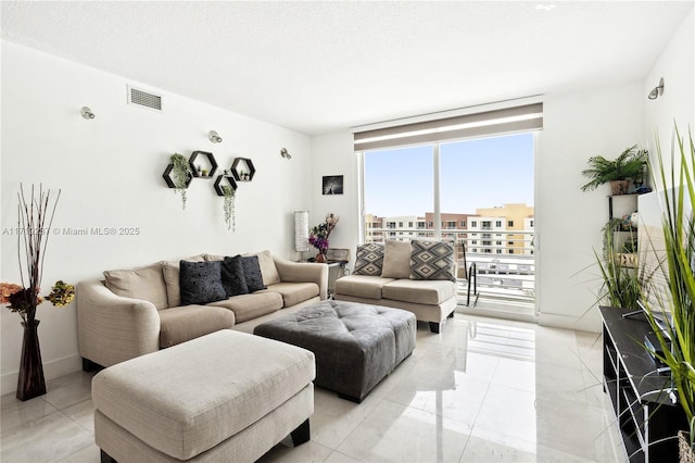 living room with a textured ceiling and expansive windows