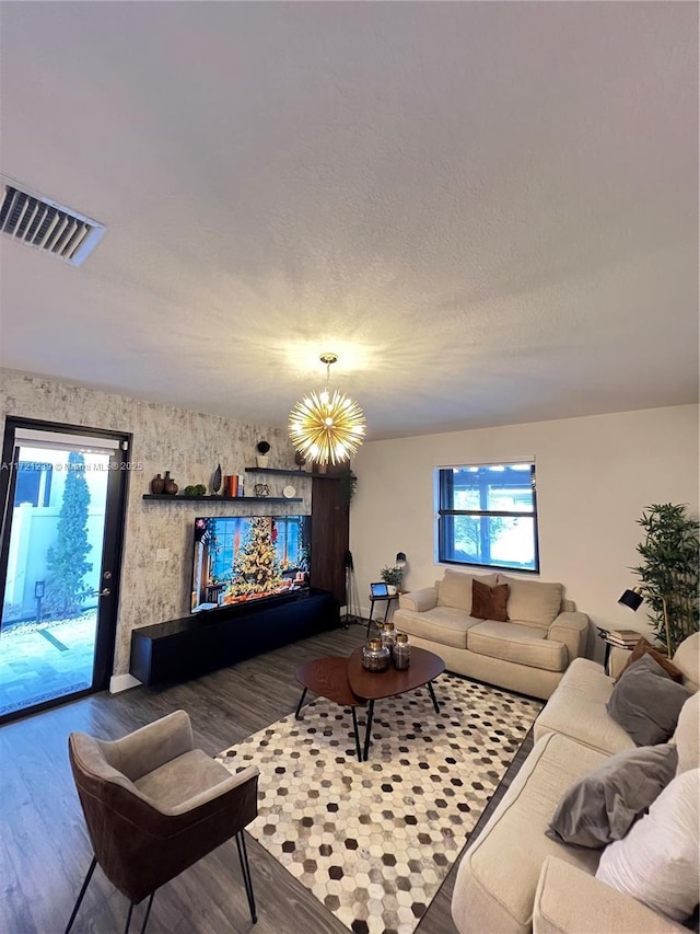 living room featuring an inviting chandelier and hardwood / wood-style floors