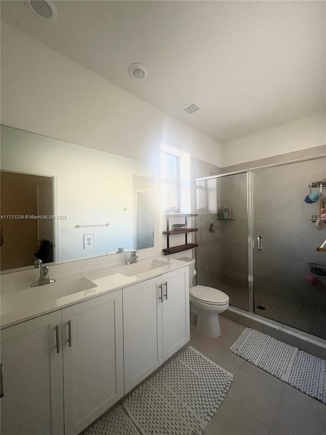 bathroom with tile patterned flooring, vanity, toilet, and walk in shower