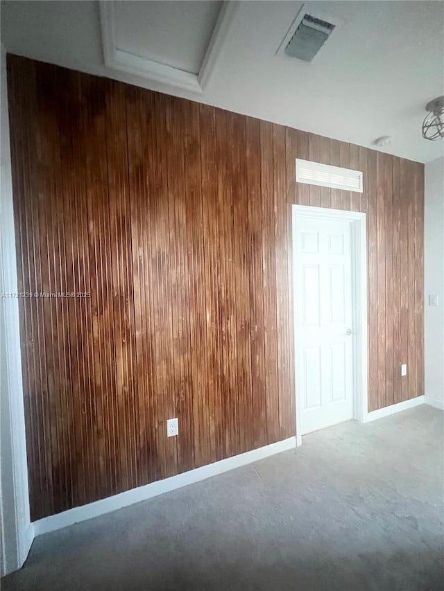 spare room featuring wooden walls