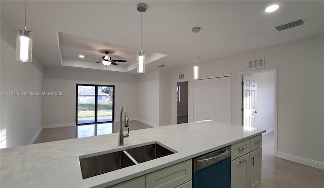 kitchen with dishwasher, a raised ceiling, sink, ceiling fan, and decorative light fixtures