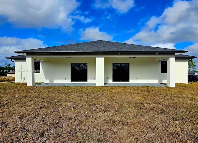 rear view of house with a lawn, ceiling fan, and a patio