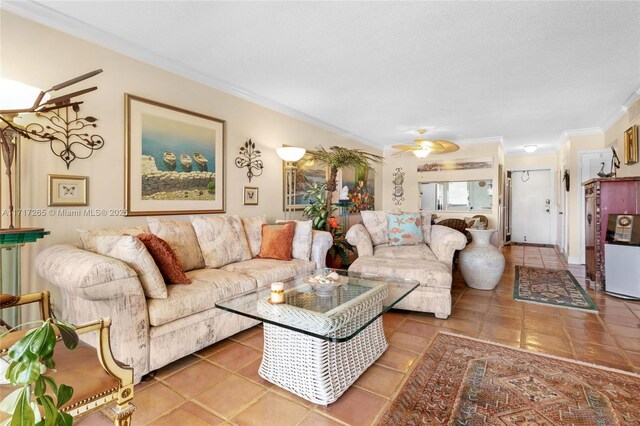 living room featuring tile patterned flooring, ceiling fan, and ornamental molding