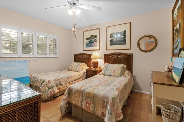 tiled bedroom featuring ceiling fan