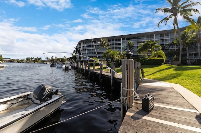 dock area featuring a water view and a yard