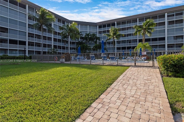 view of property's community with a lawn