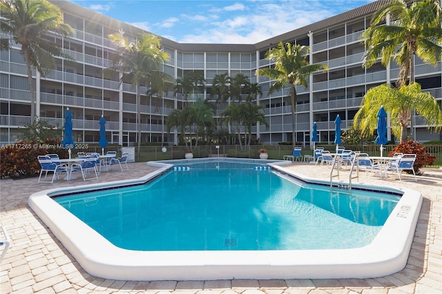 pool featuring a patio area and fence