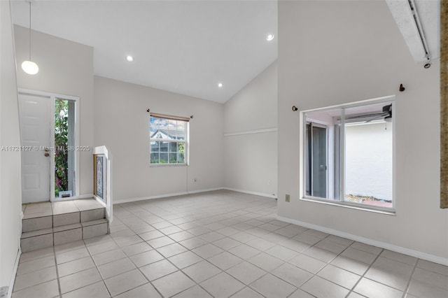 entrance foyer featuring light tile patterned floors and high vaulted ceiling