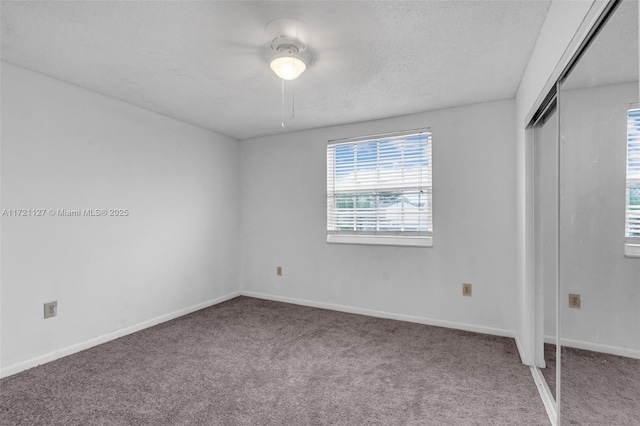 unfurnished bedroom with a closet, ceiling fan, and carpet