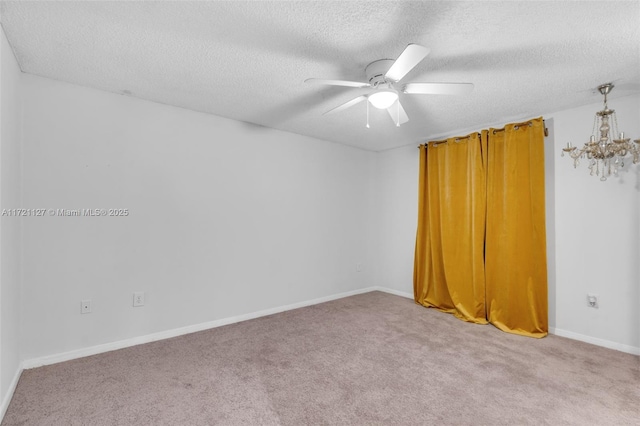 empty room with ceiling fan, light colored carpet, and a textured ceiling