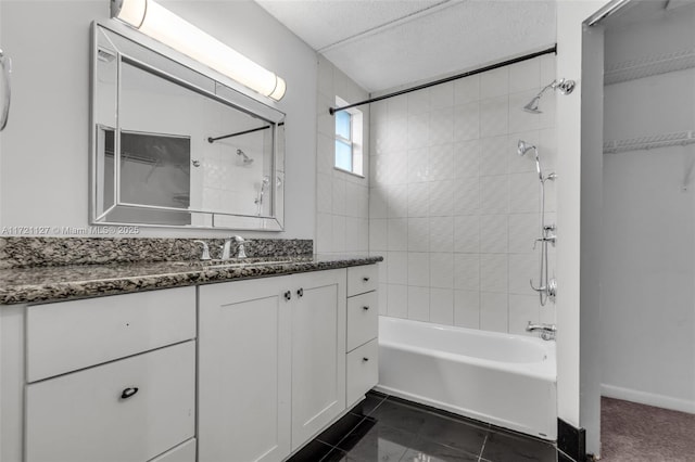 bathroom with vanity, tile patterned floors, and tiled shower / bath