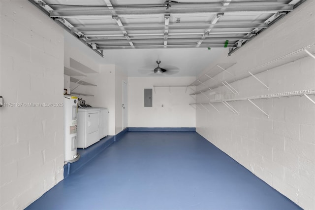 garage featuring electric water heater, electric panel, and independent washer and dryer