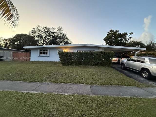 view of front of house with a yard and a carport