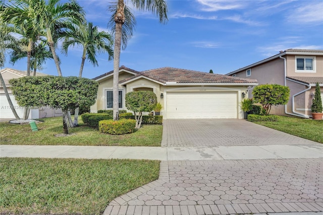 view of front of home with a front lawn and a garage