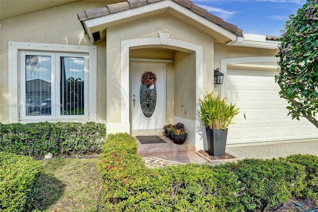 doorway to property with a garage