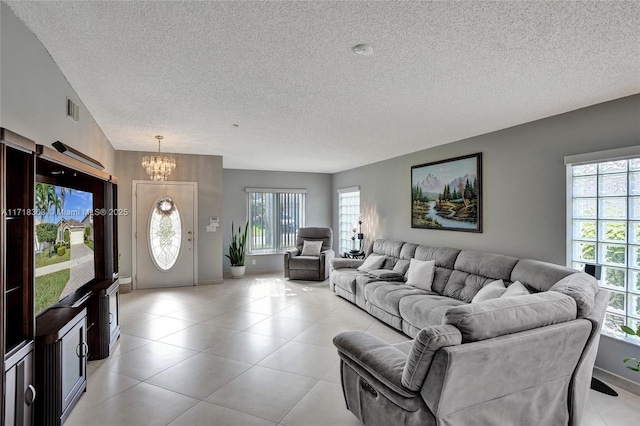 living room featuring a chandelier and a textured ceiling