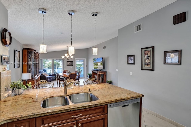 kitchen with dishwasher, pendant lighting, sink, and light tile patterned flooring