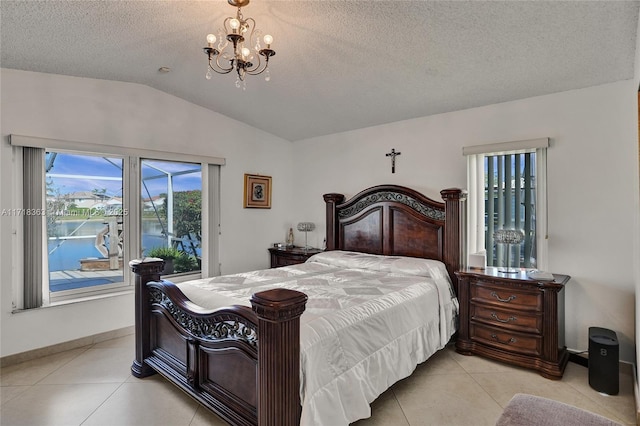 tiled bedroom with a chandelier, a textured ceiling, a water view, and vaulted ceiling