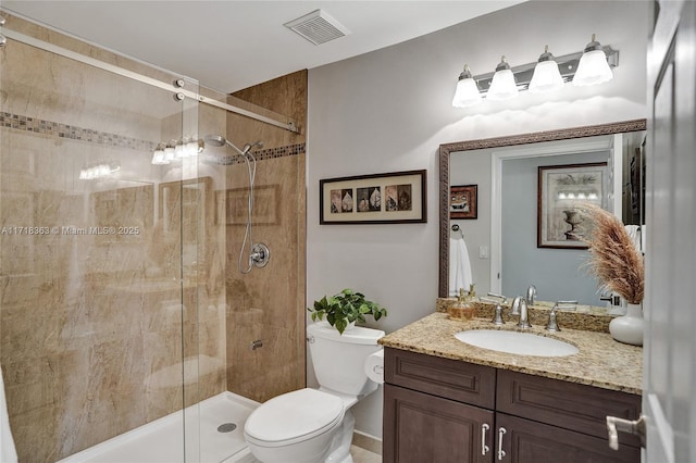 bathroom with vanity, toilet, and an enclosed shower