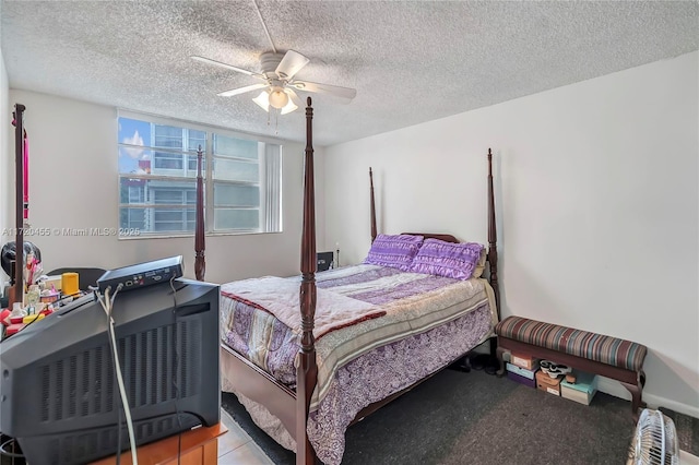 bedroom with ceiling fan and a textured ceiling