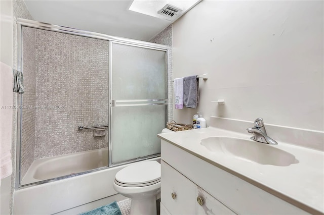 full bathroom with shower / bath combination with glass door, vanity, and toilet