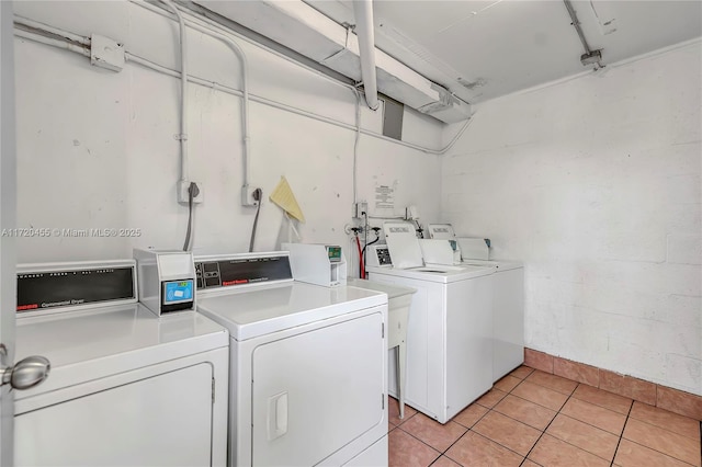 laundry room featuring washer and dryer and light tile patterned floors