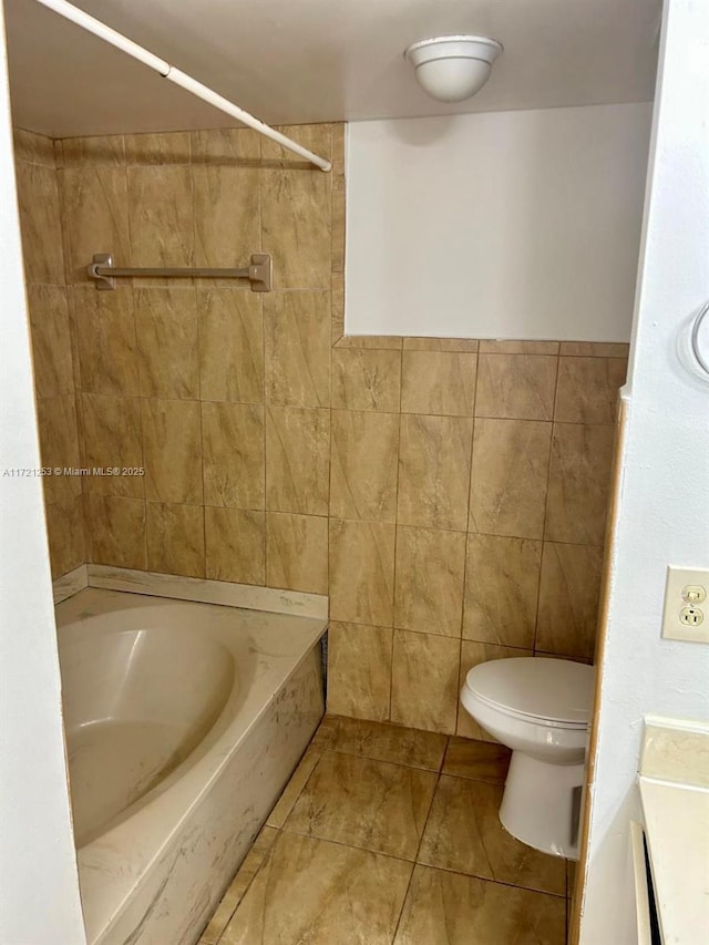 bathroom featuring tile walls, toilet, and tile patterned floors