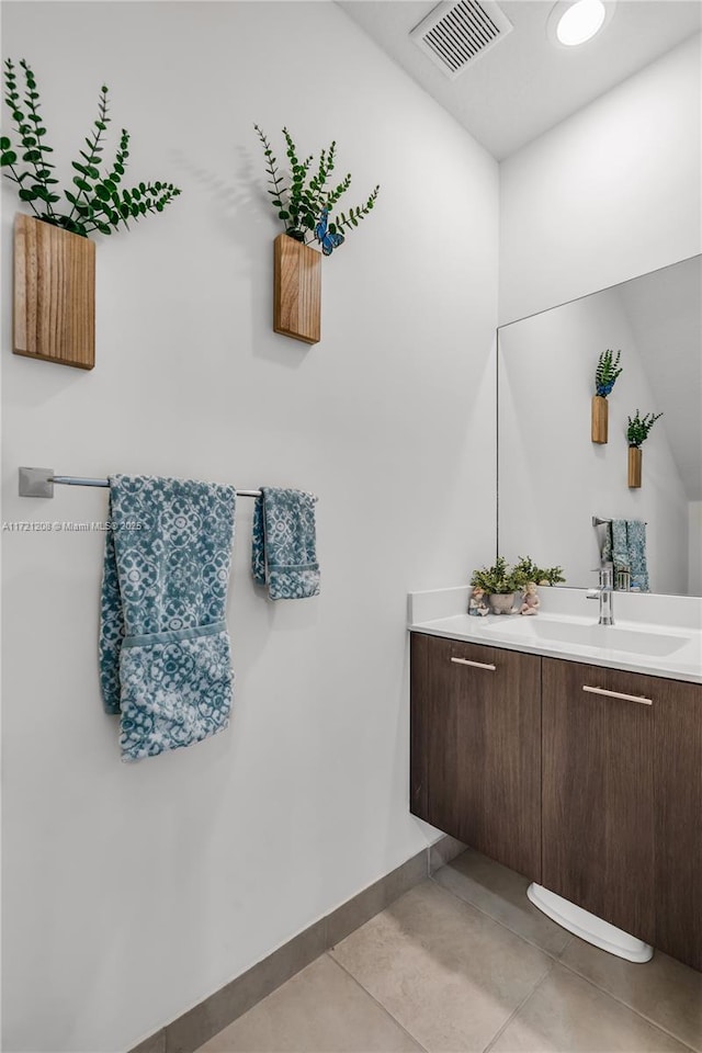 bathroom with tile patterned flooring, visible vents, baseboards, and vanity