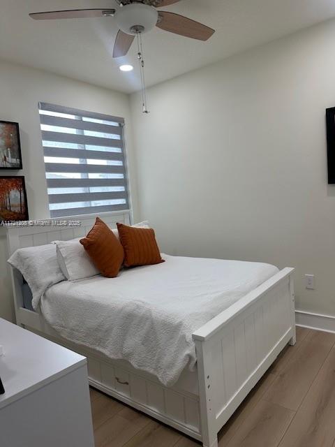 bedroom featuring ceiling fan and hardwood / wood-style floors