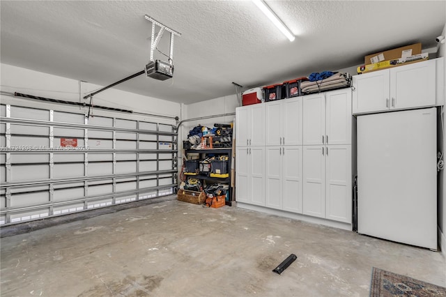 garage featuring a garage door opener and freestanding refrigerator